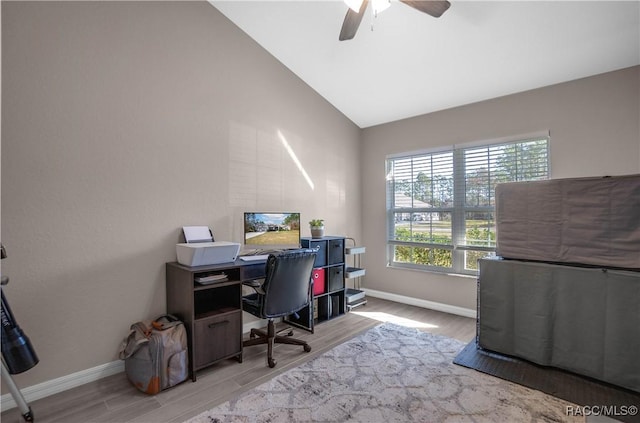 home office featuring ceiling fan, lofted ceiling, and light wood-type flooring