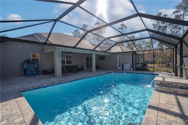 view of swimming pool featuring an outdoor hangout area, a patio area, pool water feature, and glass enclosure