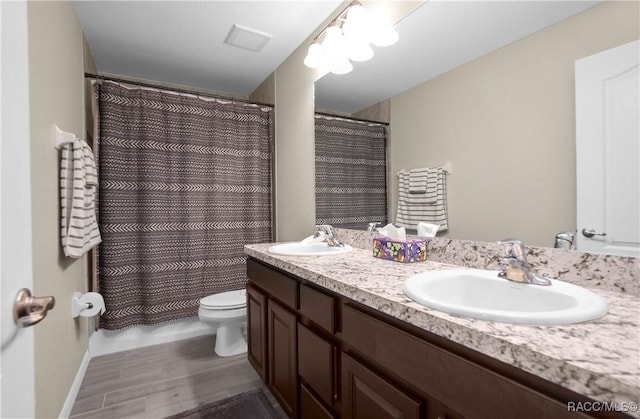 bathroom featuring vanity, curtained shower, and toilet