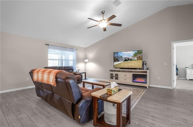 living room with ceiling fan, high vaulted ceiling, and light hardwood / wood-style floors