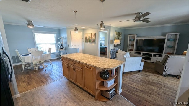 kitchen featuring decorative light fixtures, dark wood-type flooring, ceiling fan, and a kitchen island