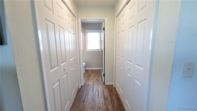 hallway with dark hardwood / wood-style flooring