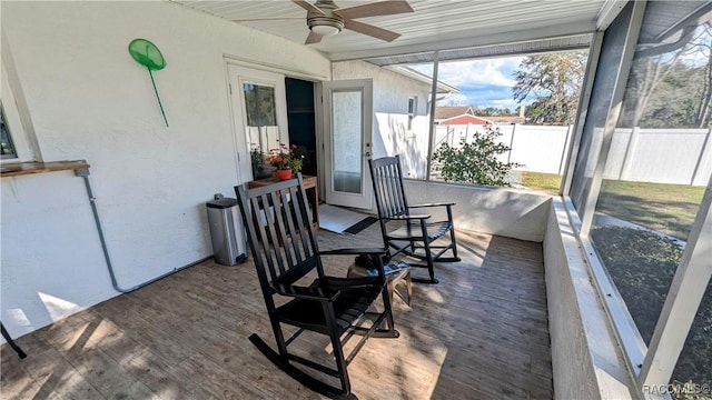 sunroom / solarium featuring ceiling fan