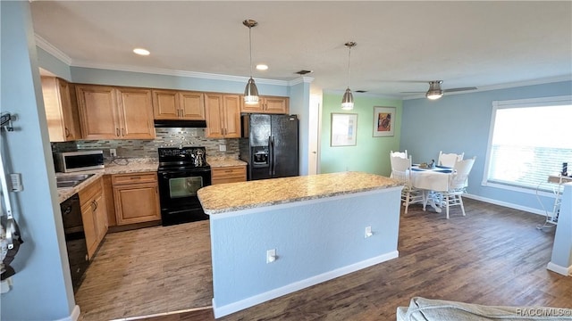 kitchen with hardwood / wood-style floors, backsplash, hanging light fixtures, a center island, and black appliances