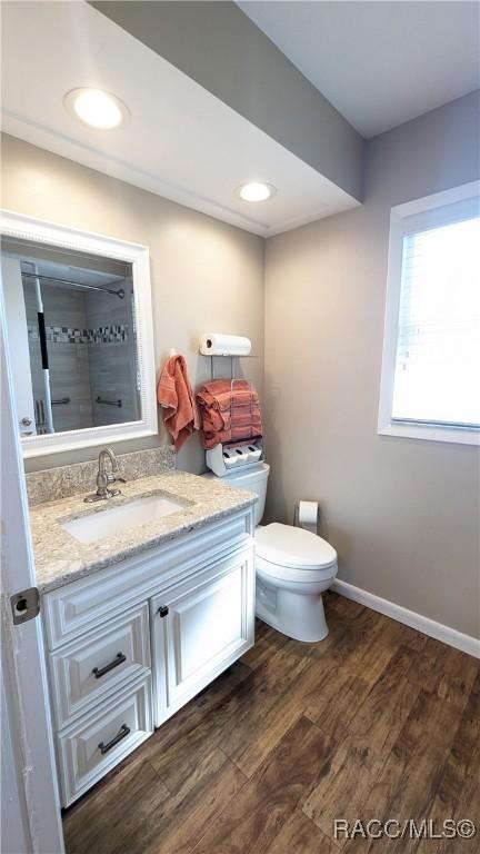 bathroom featuring vanity, hardwood / wood-style floors, and toilet