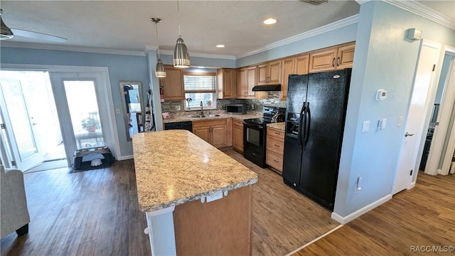 kitchen with a kitchen island, sink, backsplash, hanging light fixtures, and black appliances