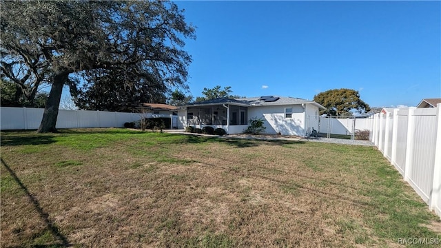 28 New Florida Ave, Beverly Hills, FL 34465 - view of yard featuring a fenced backyard and a sunroom
