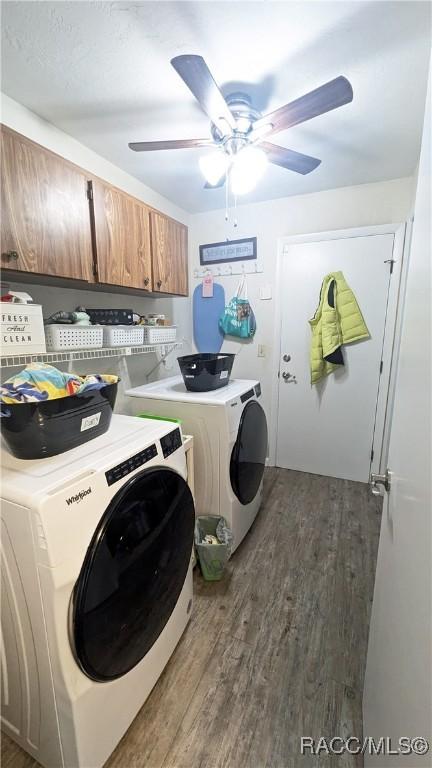 washroom with ceiling fan, cabinets, dark hardwood / wood-style flooring, and separate washer and dryer