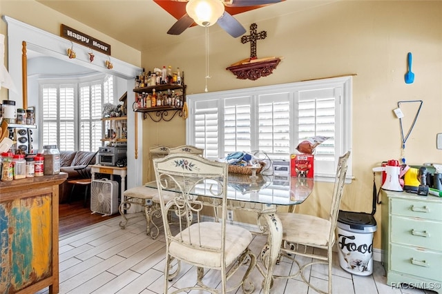 dining area featuring ceiling fan and light wood-type flooring