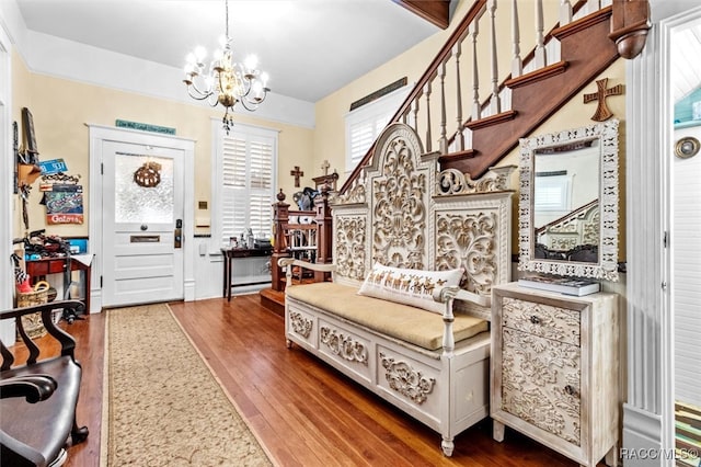 foyer entrance with dark hardwood / wood-style flooring and an inviting chandelier