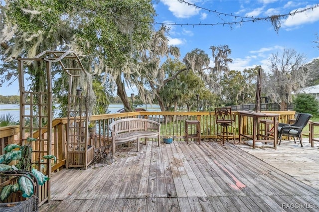 wooden deck featuring a water view