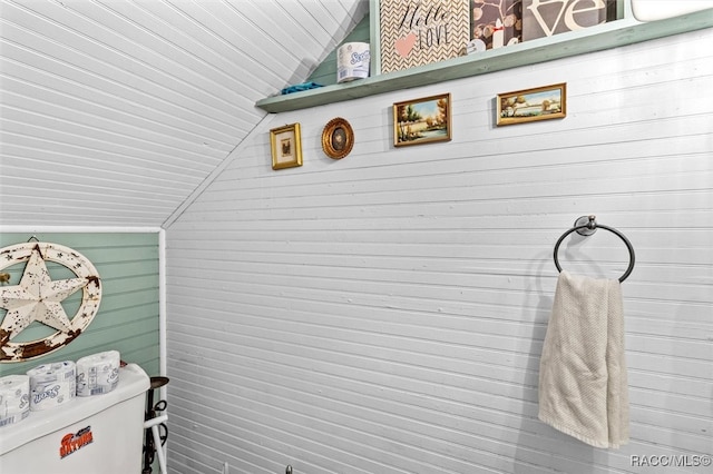 laundry room with wood walls