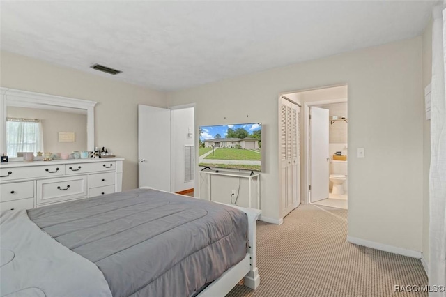 9125 N Abbot Dr, Citrus Springs, FL 34434 - bedroom featuring light carpet, baseboards, and connected bathroom