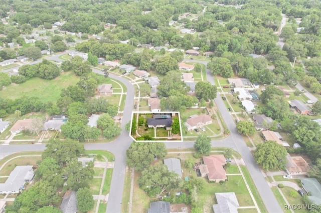 9125 N Abbot Dr, Citrus Springs, FL 34434 - aerial view of property and surrounding area with property boundaries highlighted and nearby suburban area