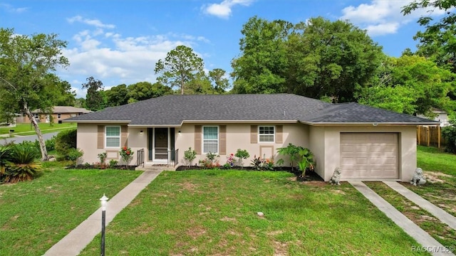 9125 N Abbot Dr, Citrus Springs, FL 34434 - single story home featuring driveway, a front yard, a garage, and stucco siding