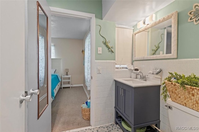 9125 N Abbot Dr, Citrus Springs, FL 34434 - bathroom with vanity, tile walls, toilet, and a wainscoted wall
