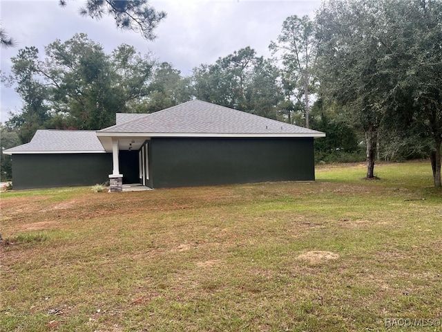 view of home's exterior with a yard