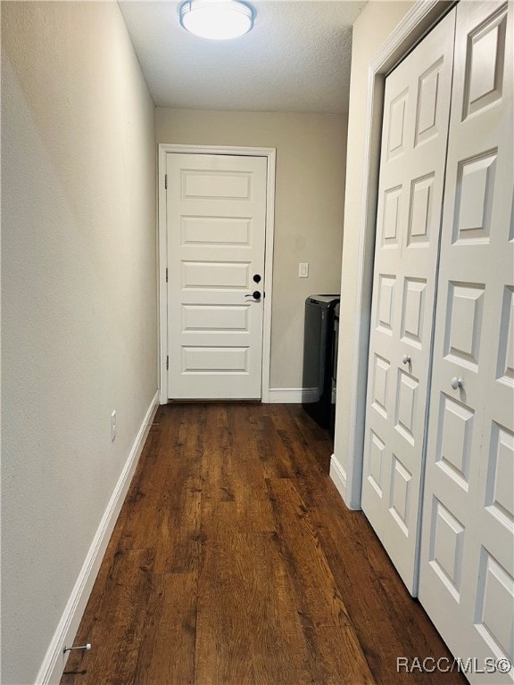 doorway featuring dark hardwood / wood-style floors and washer / dryer