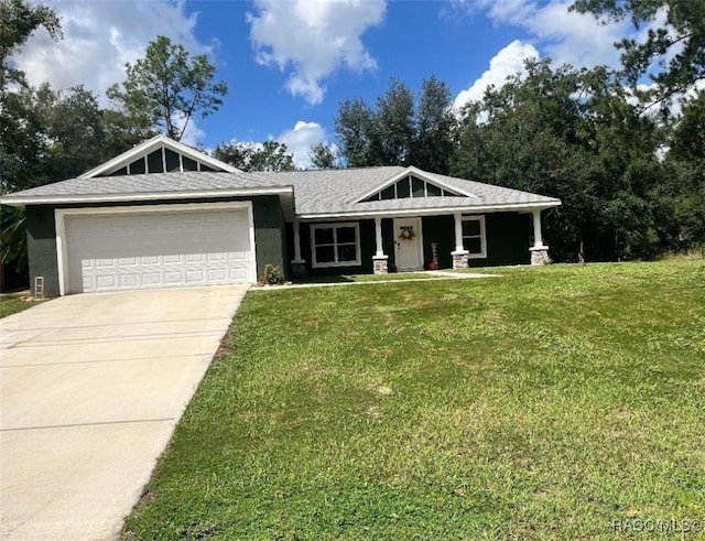 view of front of property featuring a garage and a front lawn