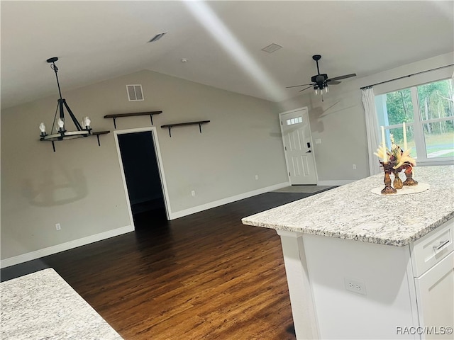 kitchen with ceiling fan, dark wood-type flooring, hanging light fixtures, lofted ceiling, and white cabinets