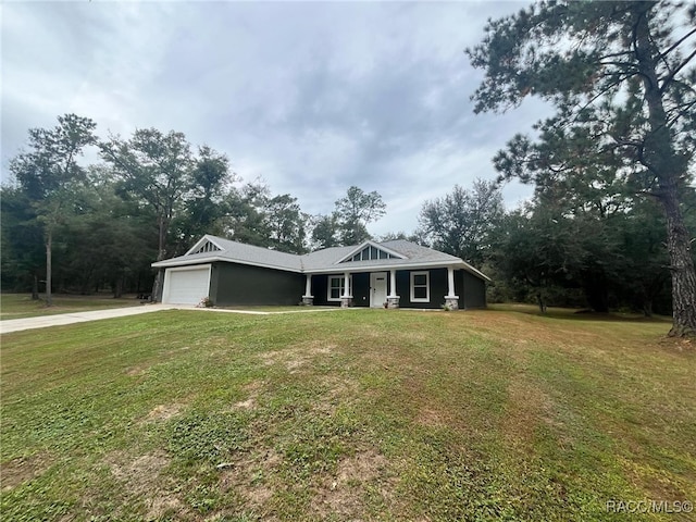 view of front of property with a garage and a front lawn