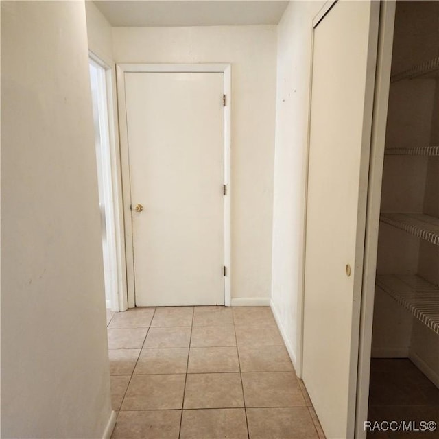 hallway featuring light tile patterned floors