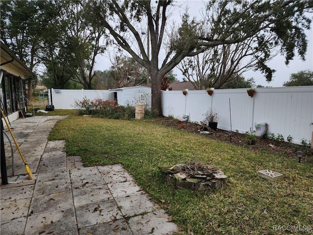 view of yard with a fire pit and a patio area