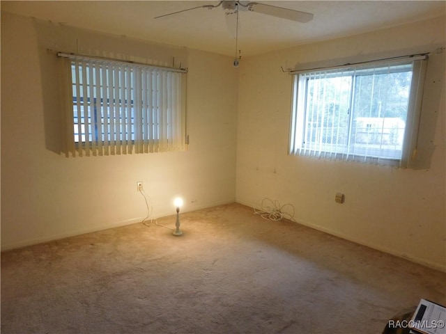 carpeted empty room featuring ceiling fan