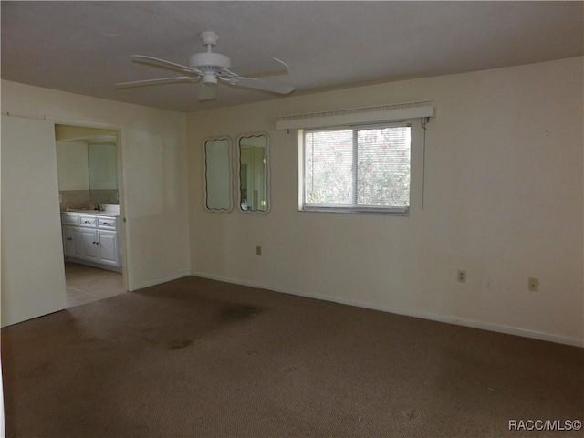 spare room with light colored carpet and ceiling fan