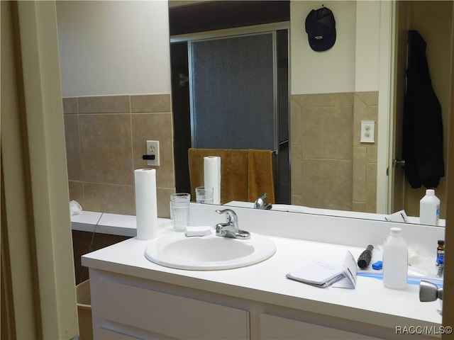 bathroom with vanity and tile walls