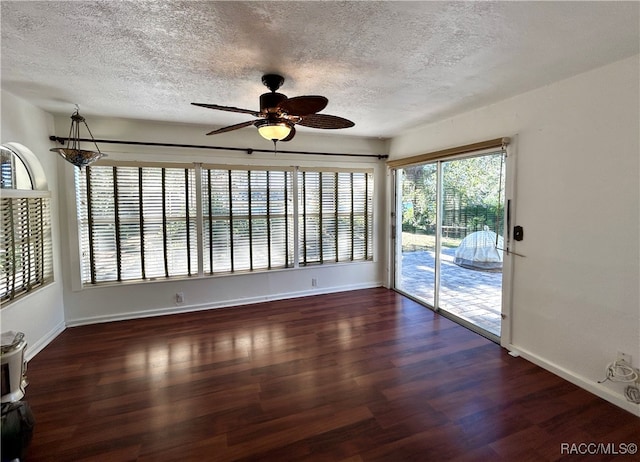 spare room with ceiling fan, dark wood-type flooring, and a textured ceiling