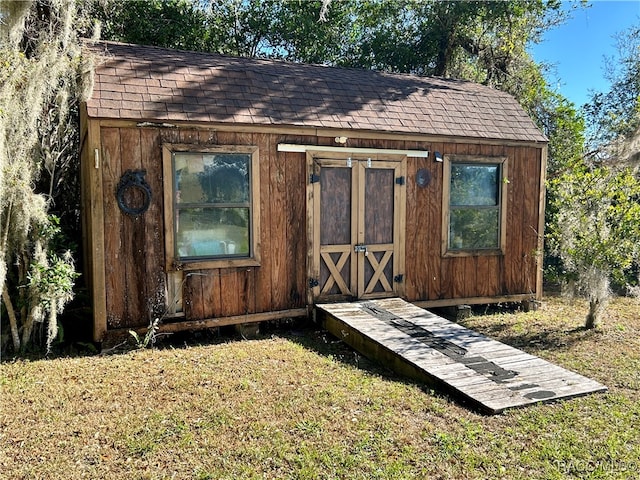 view of outbuilding featuring a yard