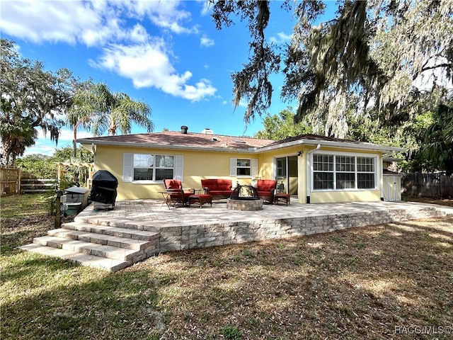 back of property with outdoor lounge area and a patio