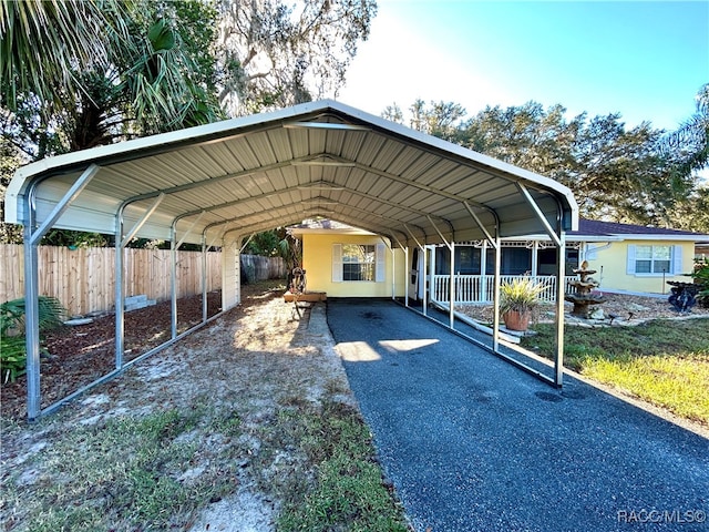 view of parking / parking lot featuring a carport