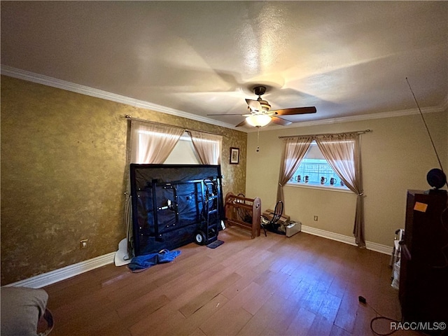 interior space with crown molding, ceiling fan, and wood-type flooring