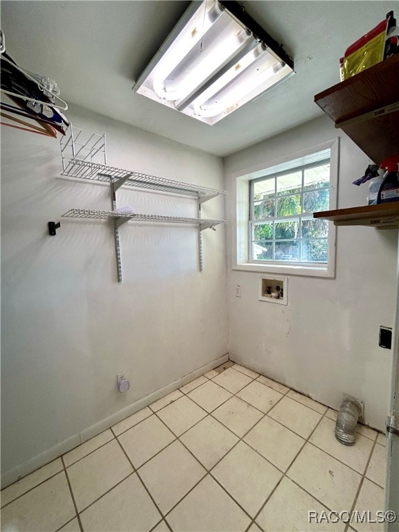 laundry room featuring hookup for a washing machine and light tile patterned floors