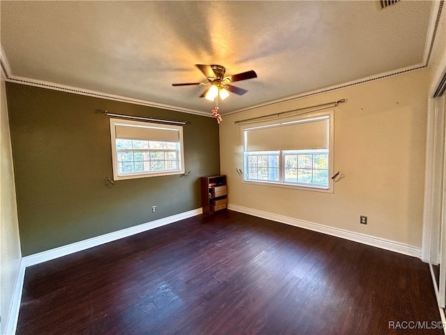 unfurnished room with a textured ceiling, dark hardwood / wood-style flooring, ceiling fan, and crown molding