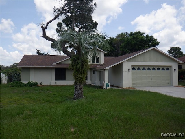 view of front of property with a garage and a front yard