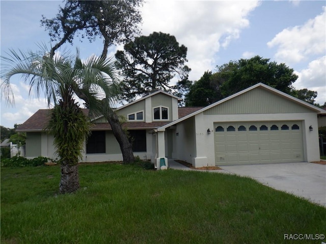 view of front of property featuring a garage and a front yard