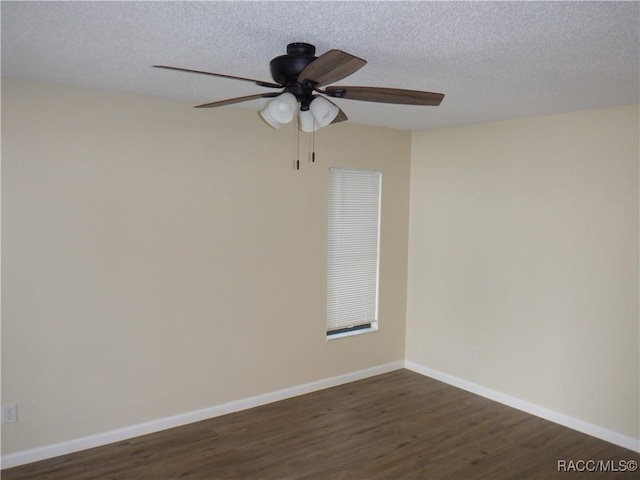 empty room featuring ceiling fan, dark hardwood / wood-style flooring, and a textured ceiling