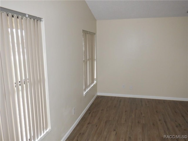 unfurnished room featuring dark hardwood / wood-style flooring