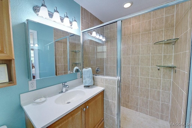 bathroom with vanity and a stall shower