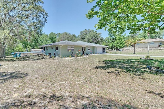 rear view of house featuring a swimming pool