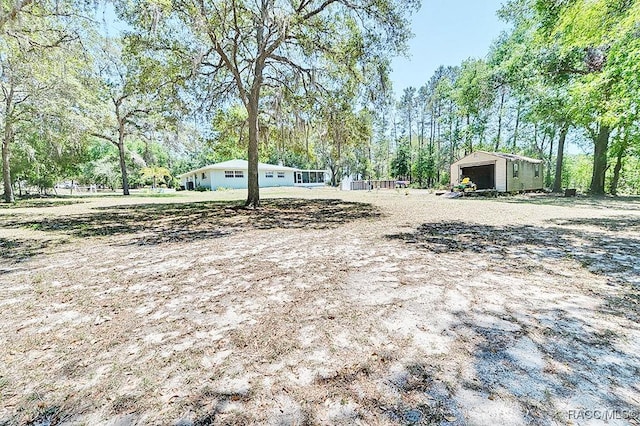 view of yard featuring an outbuilding and a garage