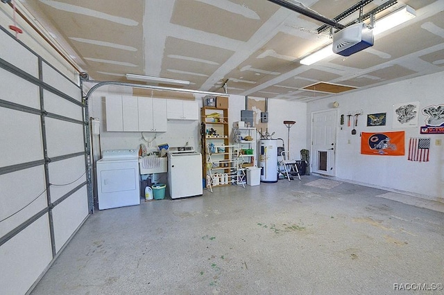 garage featuring separate washer and dryer, a garage door opener, a sink, and water heater
