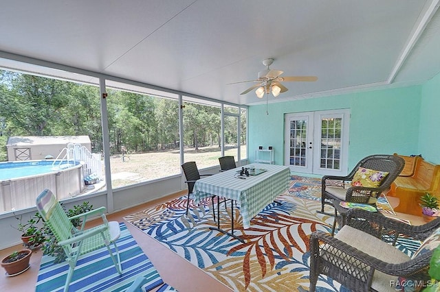 sunroom / solarium with a ceiling fan, french doors, and an outdoor hangout area