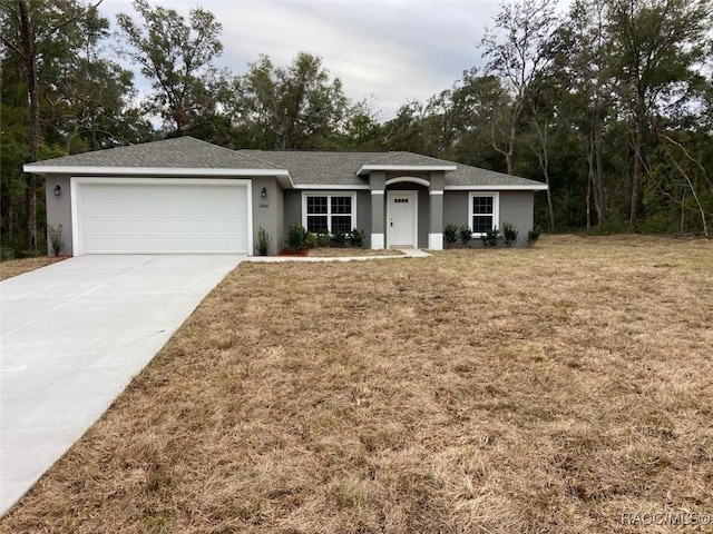 ranch-style house with a garage and a front lawn