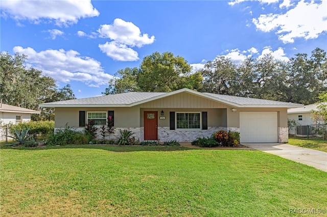 single story home featuring a garage and a front lawn