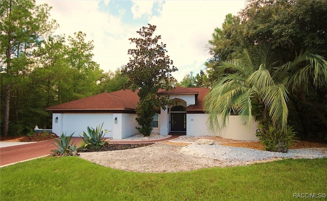 view of front of home featuring a garage and a front lawn