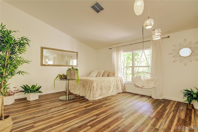 bedroom featuring hardwood / wood-style flooring and lofted ceiling